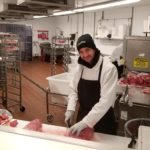 A UFCW Local 152 member slicing meat