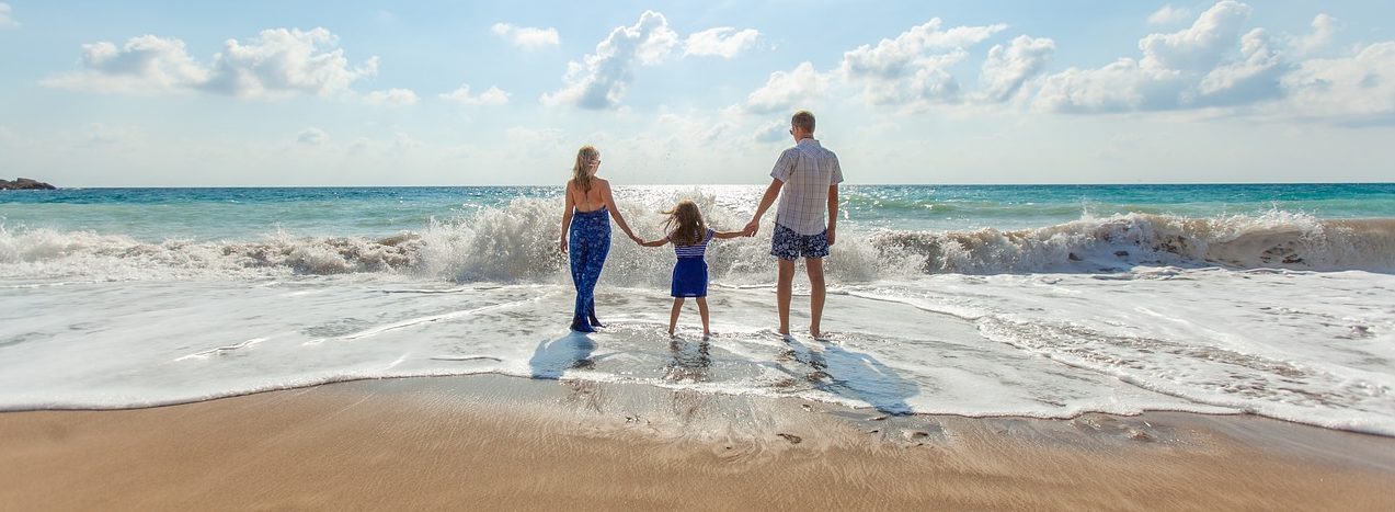 A family jumping on the beach