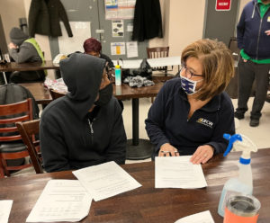 A worker at Brown's/Fresh Grocer learning about the new contract with Assistant Director of Collective Bargaining Lisa Sanders, 2/2/2022.
