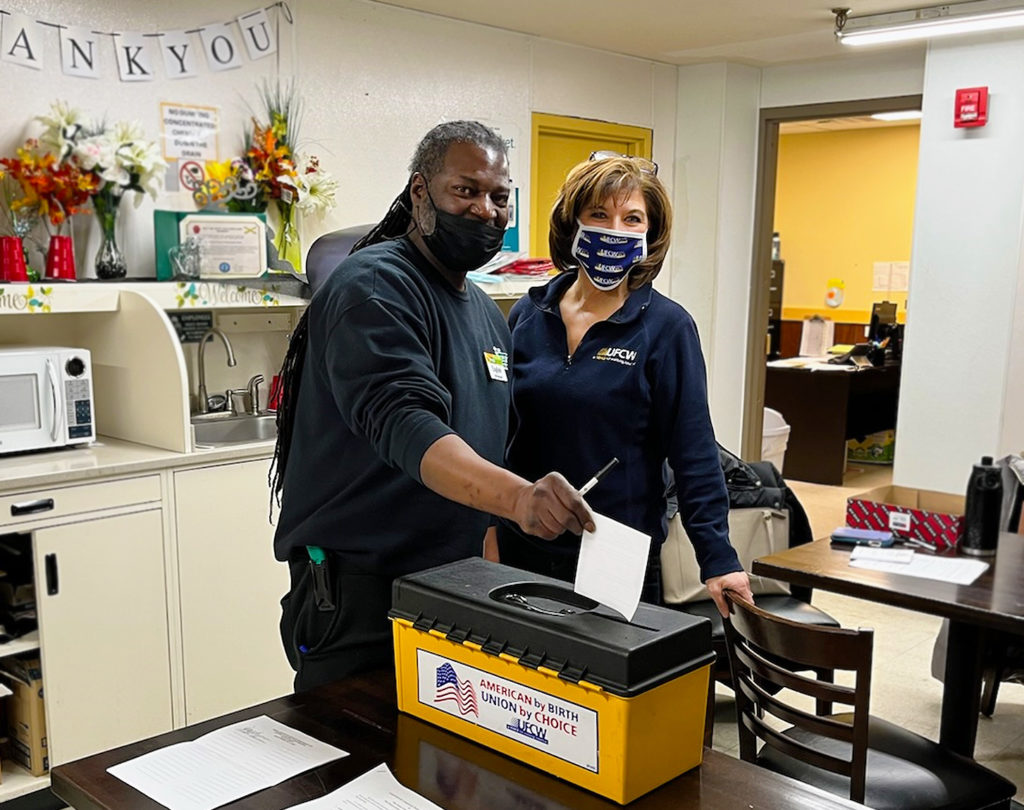 Assistant Director of Collective Bargaining Lisa Sanders with Local 152 member English as he casts his vote on 2/2/2022.