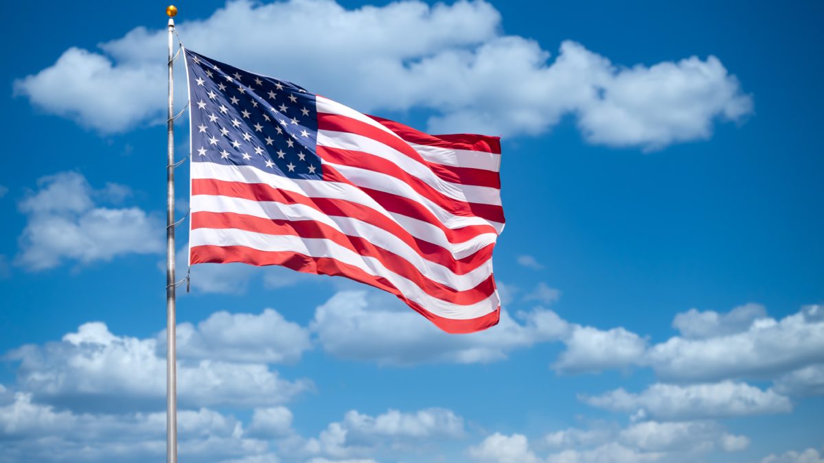 American flag with a sky background