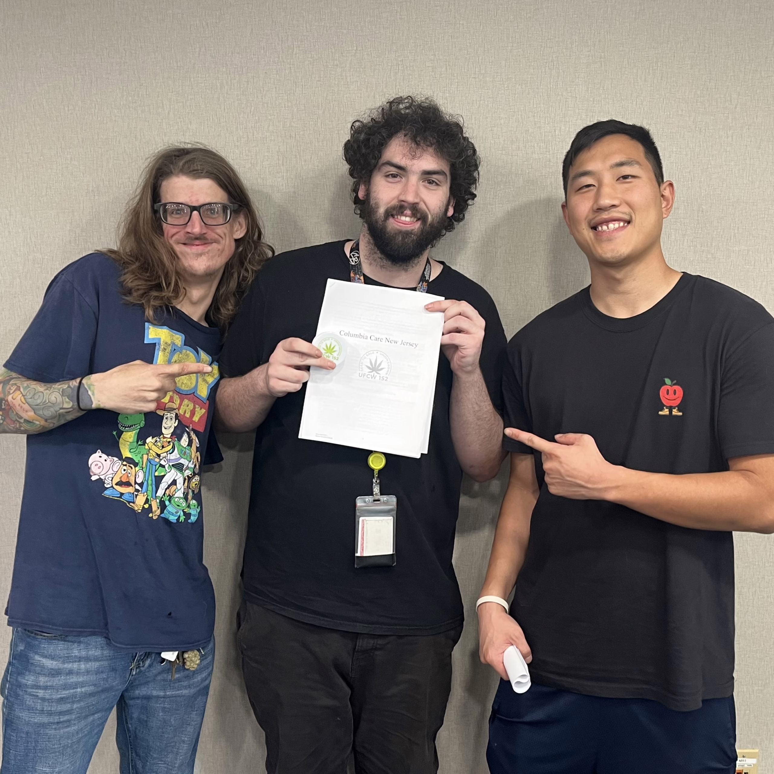 Columbia Care workers showing their newly ratified contract, 2025.